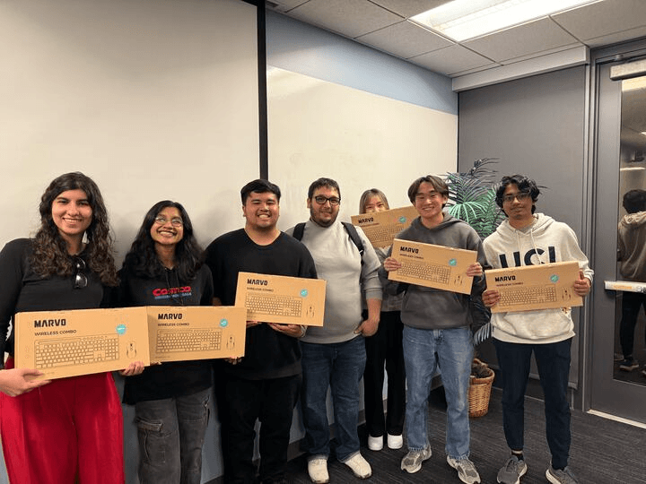 A winning team holding their prizes