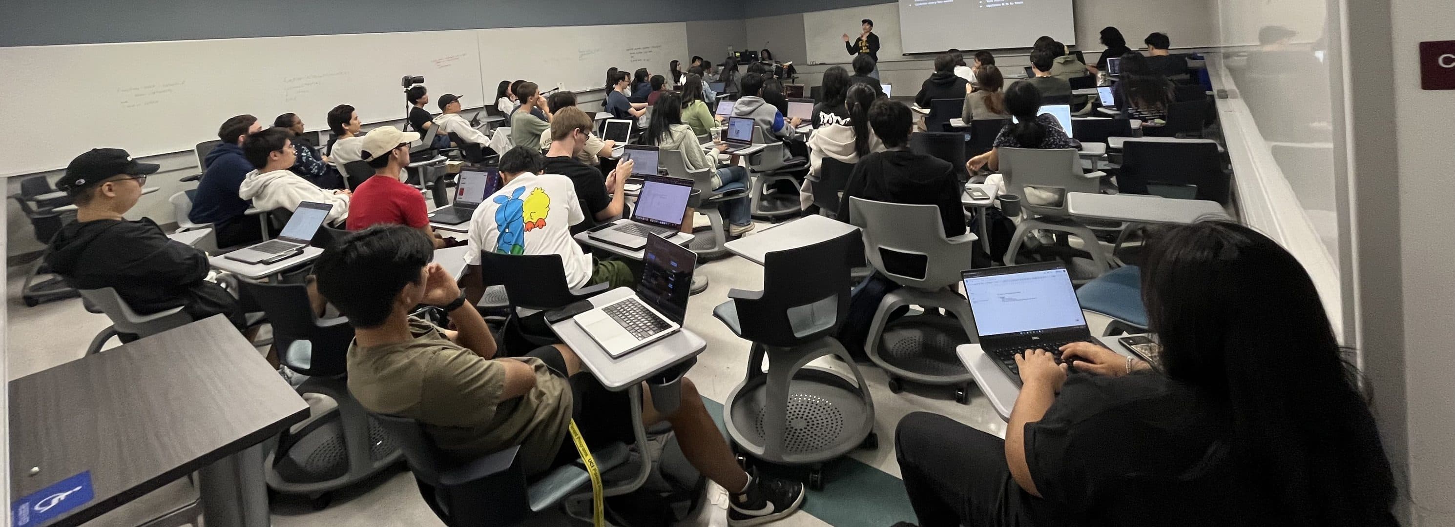 A packed classroom working during a workshop